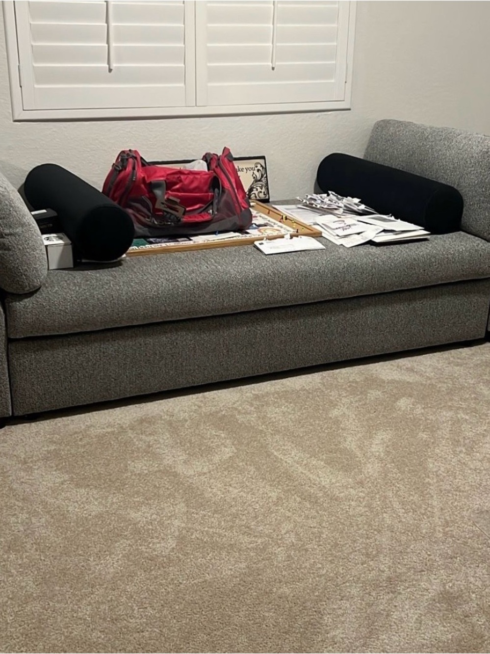 Gray Upholstered Daybed with Black Bolster Pillows